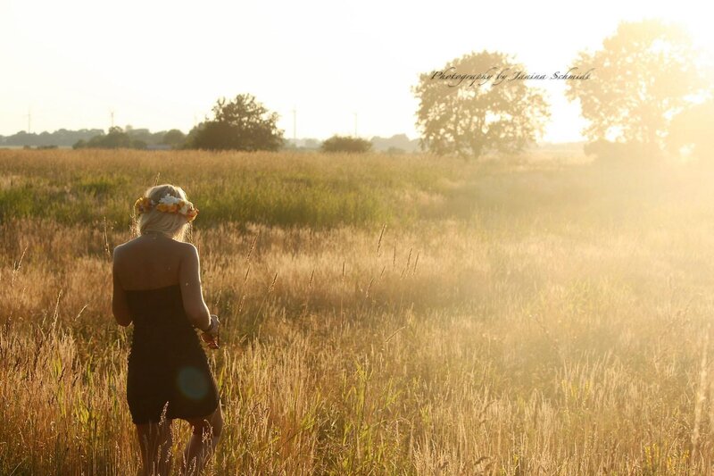 woman in field at sunset