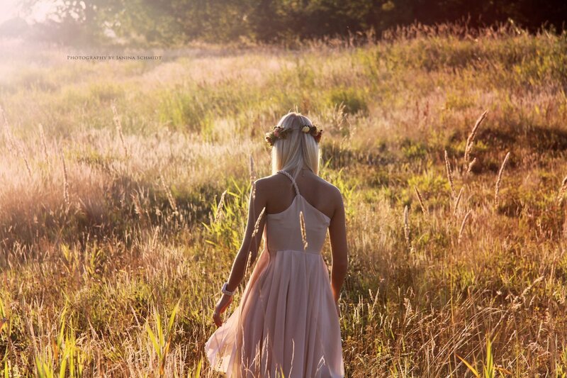 Woman in field at sunset