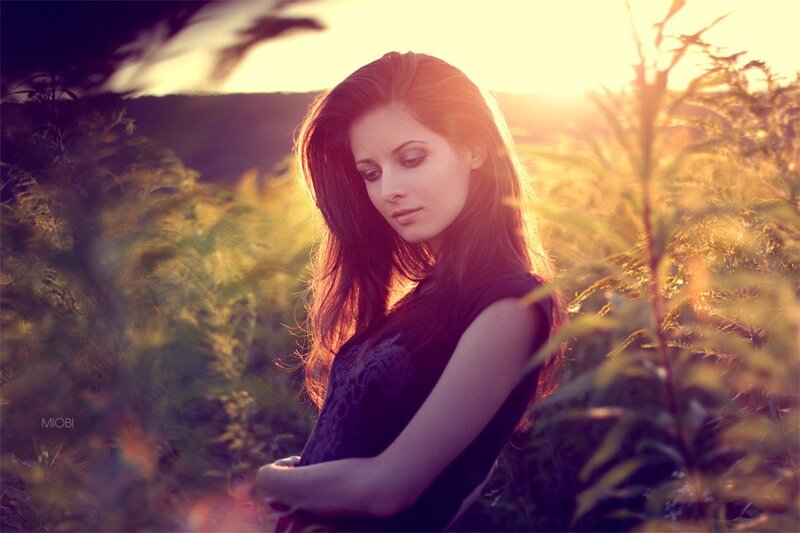 woman in field at sunset