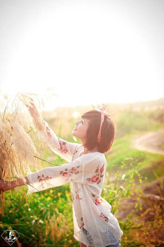woman in field at sunset