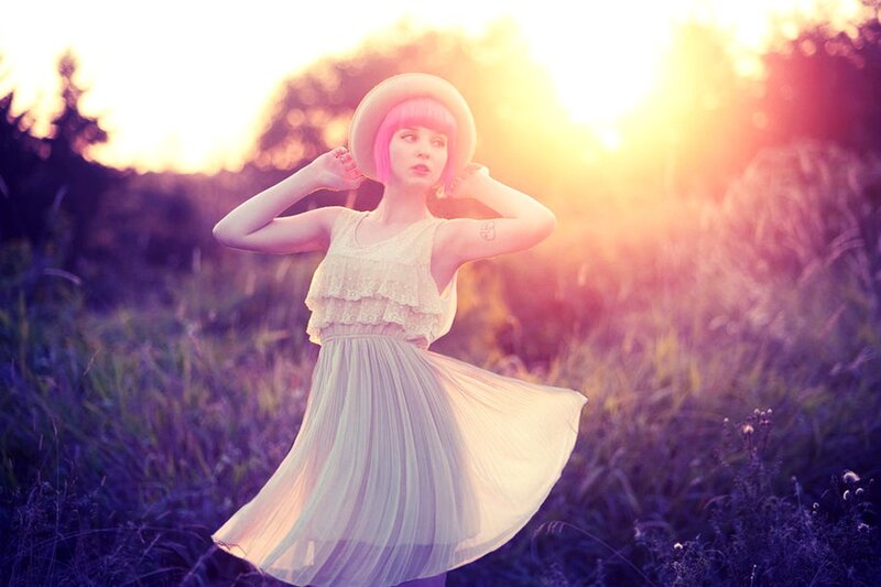 woman in field at sunset