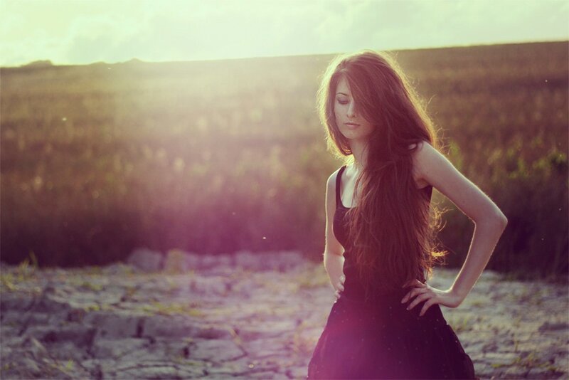 woman in field at sunset