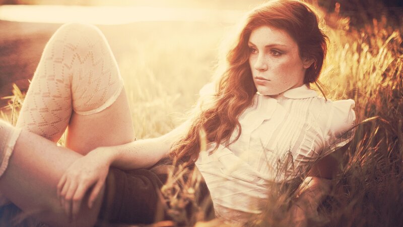 woman in field at sunset
