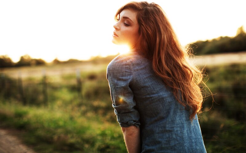 woman in field at sunset