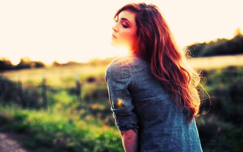 woman in field at sunset