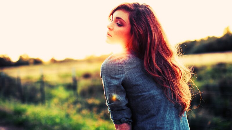woman in field at sunset