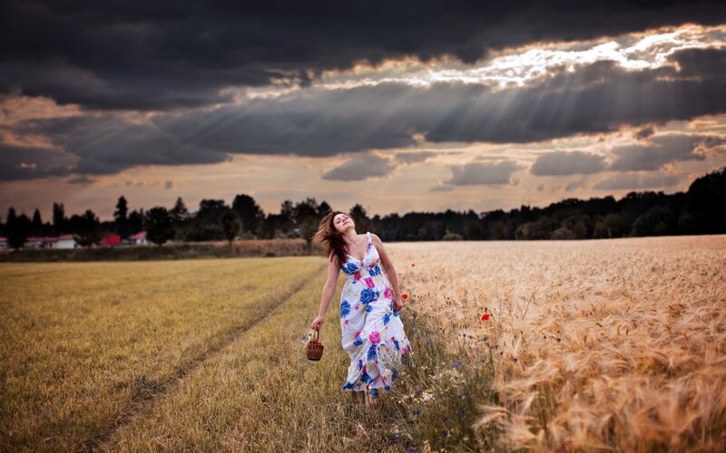 Woman in field at sunset