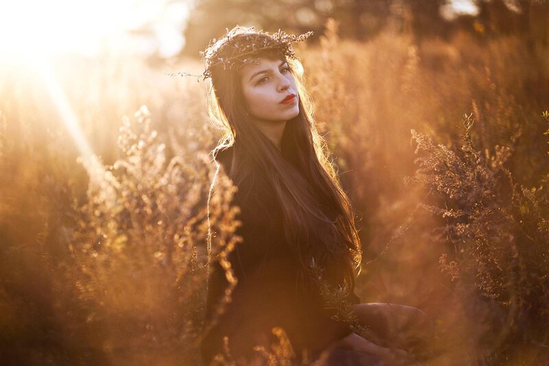 woman in field at sunset