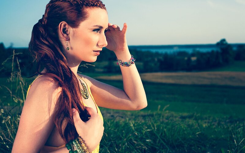 Woman in field at sunset