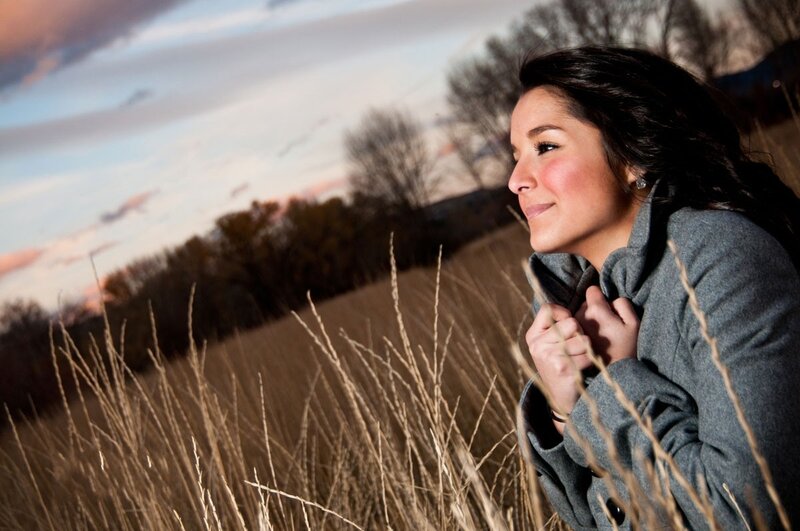 woman in field at sunset