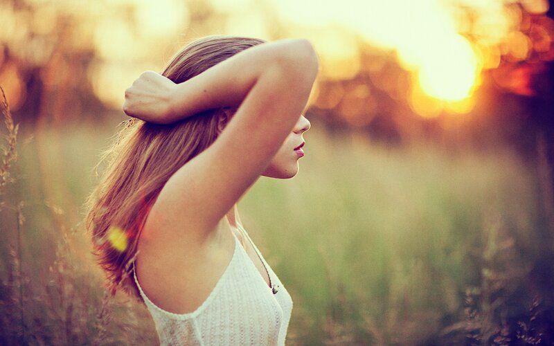 woman in field at sunset