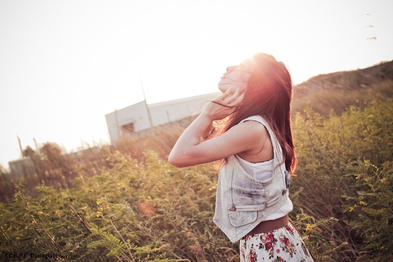 woman in field at sunset
