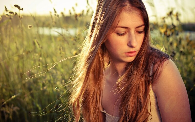 woman in field at sunset