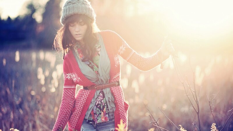 woman in field at sunset
