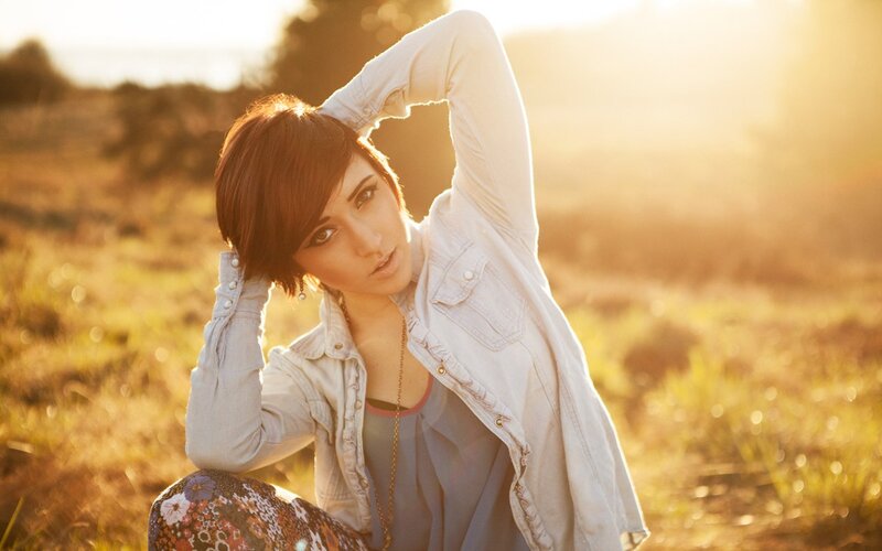 woman in field at sunset