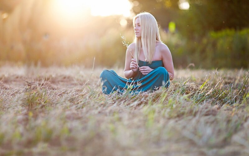 woman in field at sunset