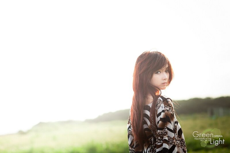 woman in field at sunset
