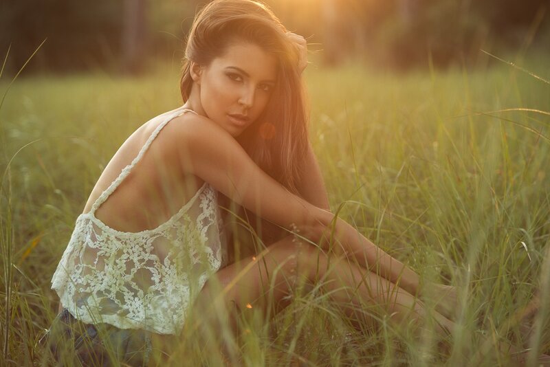 woman in field at sunset