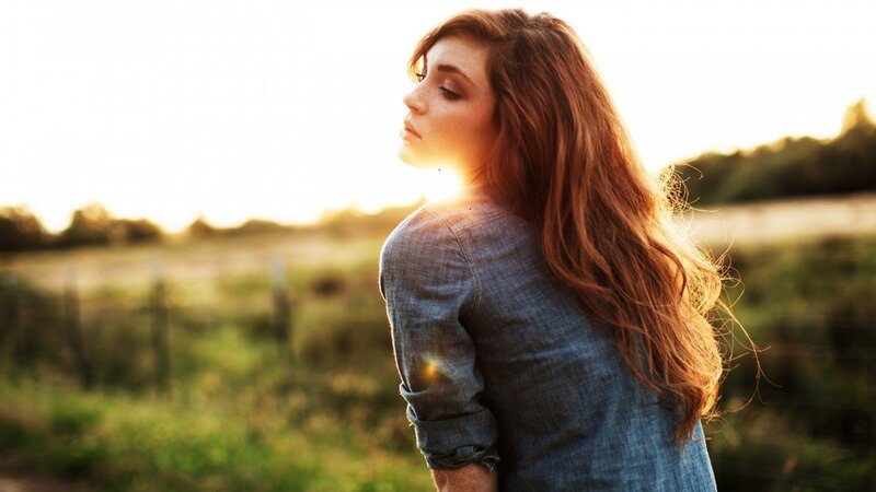 woman in field at sunset