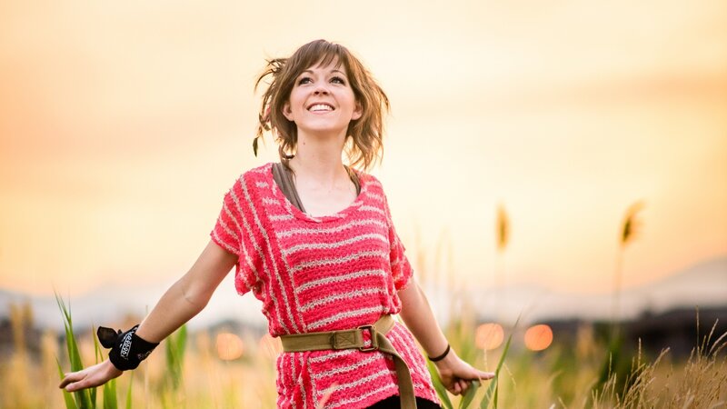 woman in field at sunset