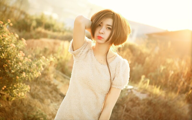woman in field at sunset