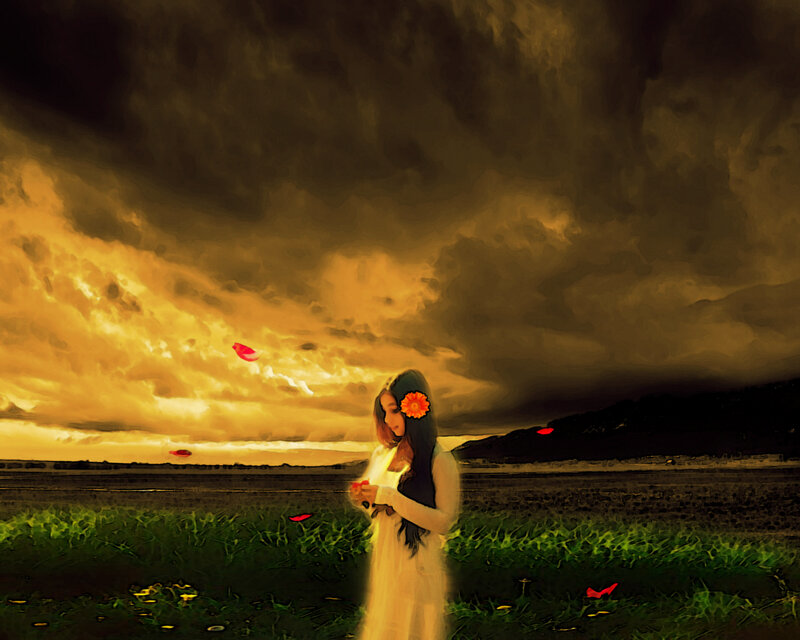 Woman in field at sunset