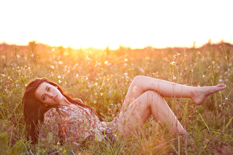 Woman in field at sunset