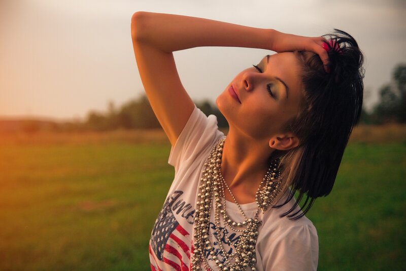 woman in field at sunset