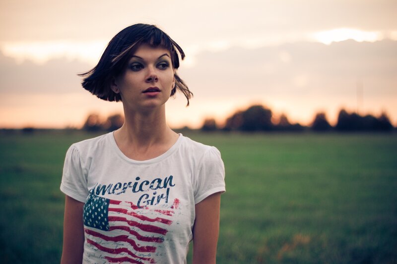 woman in field at sunset