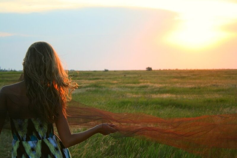 Woman in field at sunset