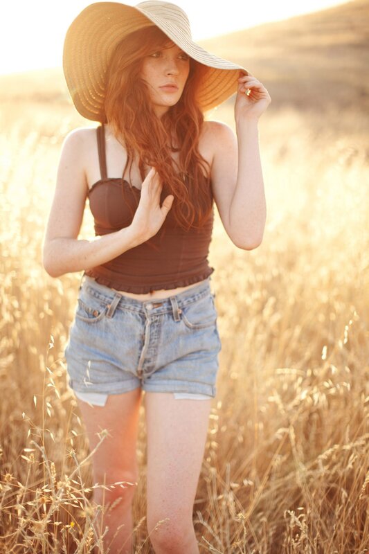 woman in field at sunset