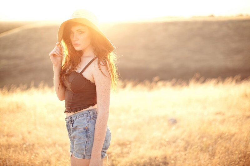 woman in field at sunset