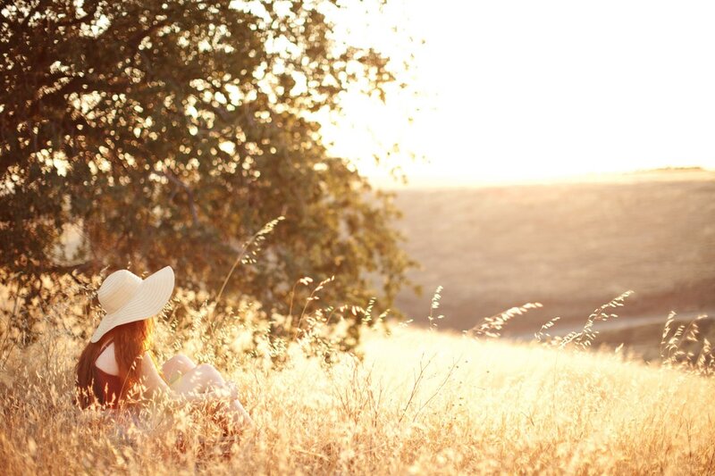 Woman in field at sunset