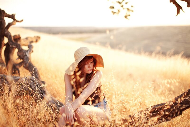 Woman in field at sunset