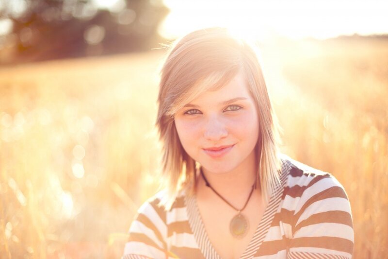 woman in field at sunset