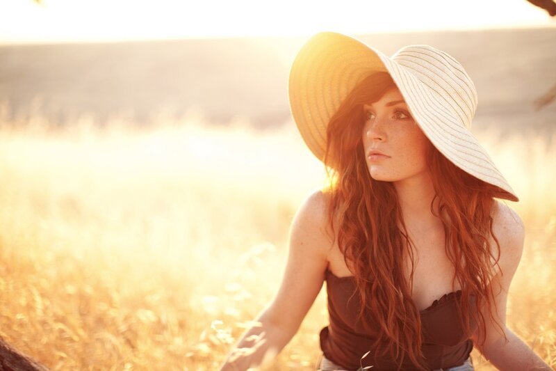 woman in field at sunset
