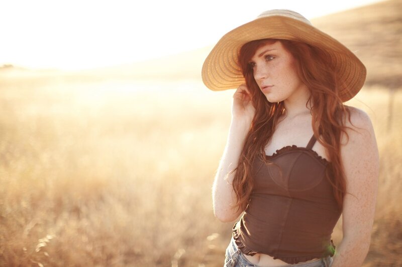 woman in field at sunset