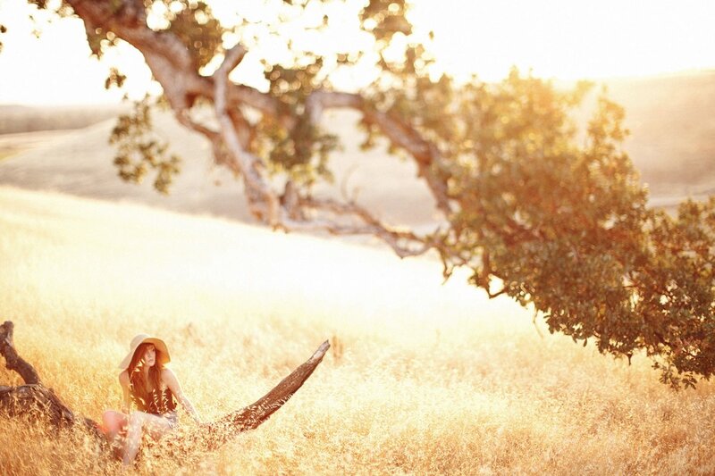 woman in field at sunset