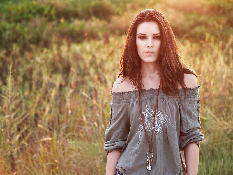 woman in field at sunset