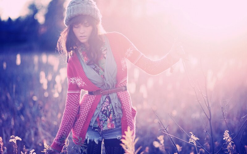 woman in field at sunset