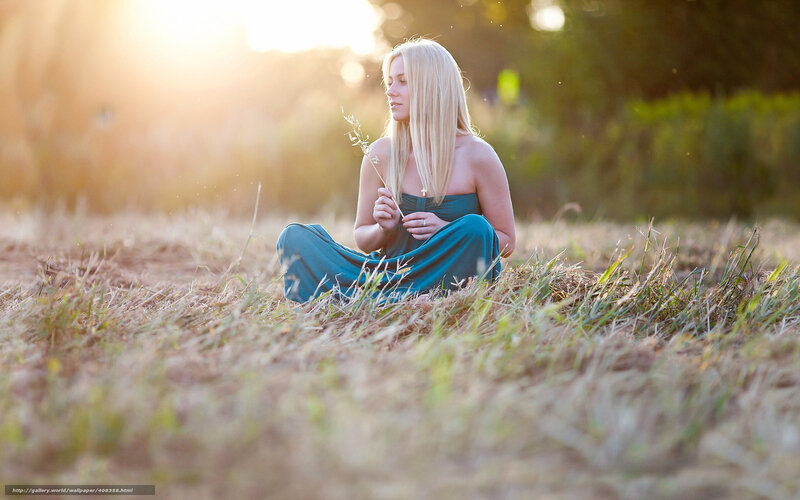 Woman in field at sunset