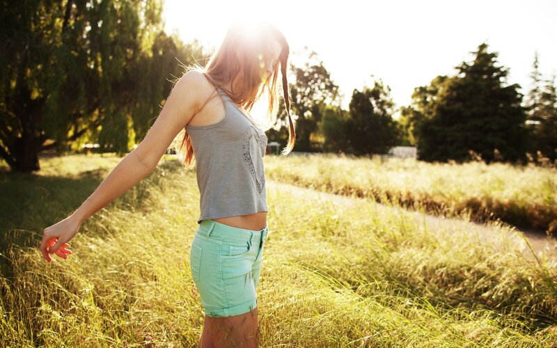 woman in field at sunset