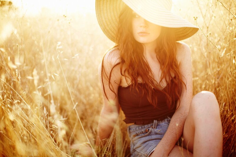 woman in field at sunset