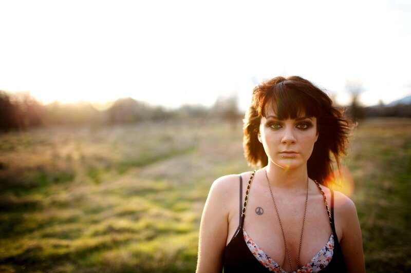 woman in field at sunset