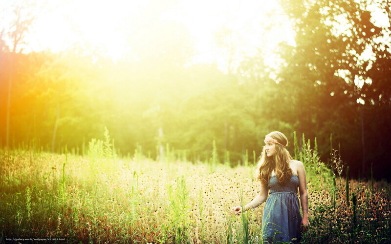 woman in field at sunset