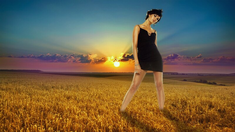 Woman in field at sunset