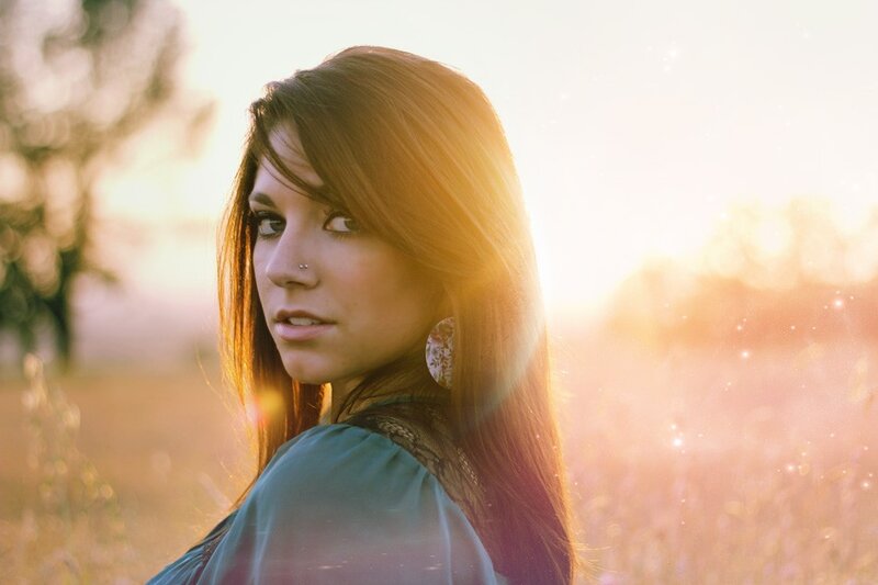 woman in field at sunset