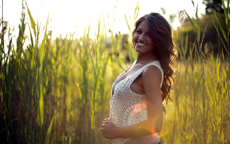 Woman in field at sunset