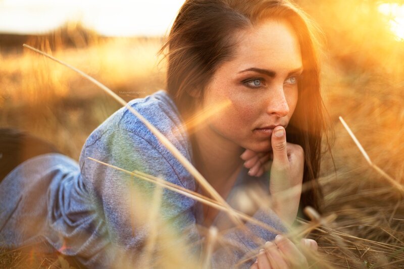 woman in field at sunset