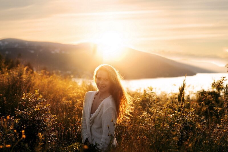 Woman in field at sunset